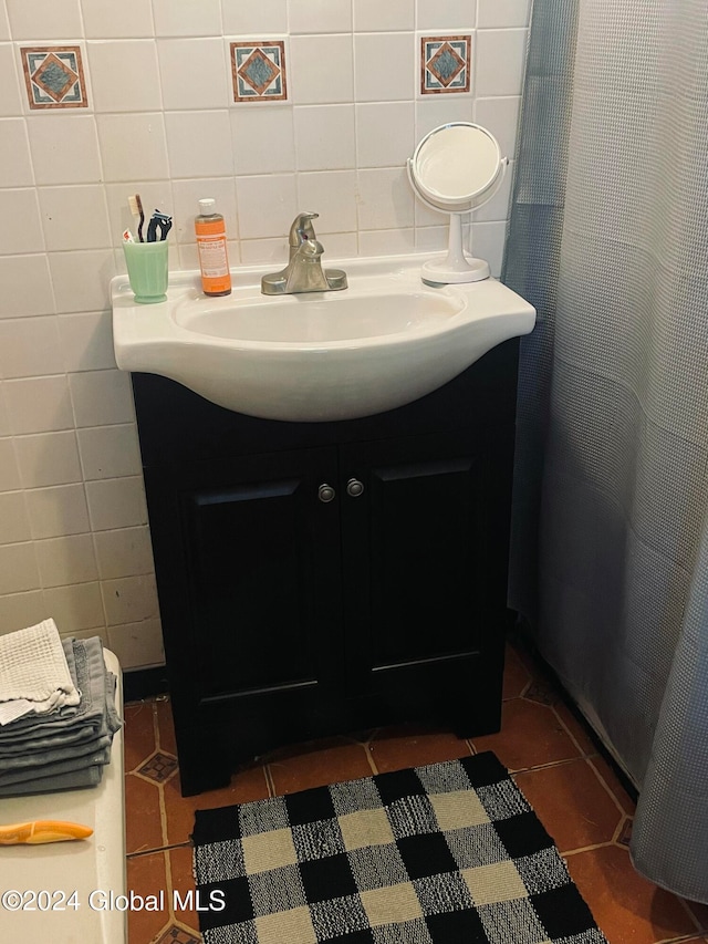 bathroom featuring tile patterned floors, tasteful backsplash, vanity, and tile walls