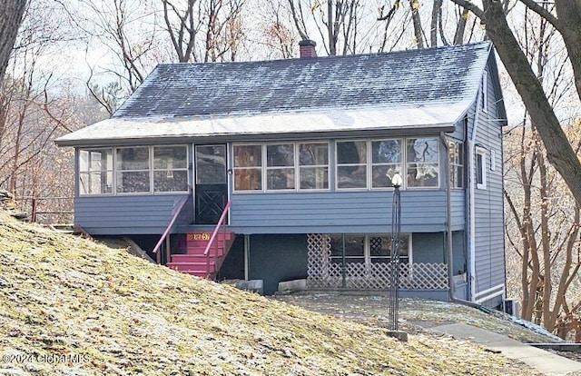 view of front of property featuring a sunroom