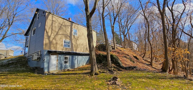 view of side of home with a lawn