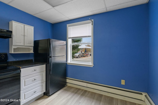 kitchen with black appliances, light hardwood / wood-style floors, white cabinets, and a baseboard heating unit