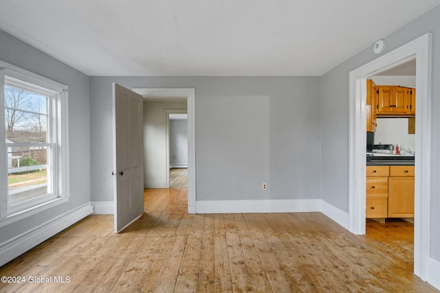 spare room featuring light wood-type flooring