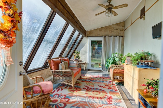 sunroom with vaulted ceiling with beams, a healthy amount of sunlight, and ceiling fan