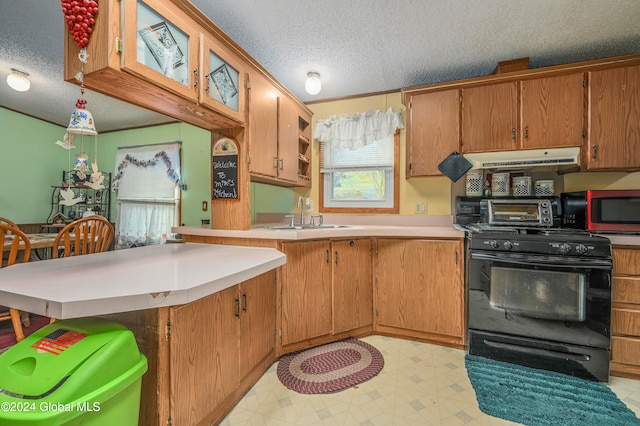 kitchen featuring kitchen peninsula, a textured ceiling, black range with electric stovetop, and sink