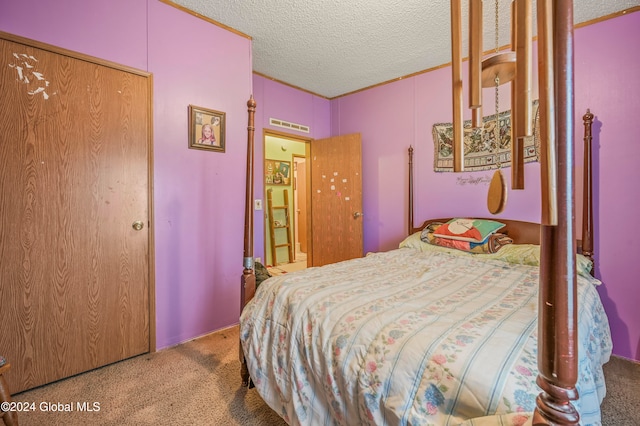 carpeted bedroom with a textured ceiling and a closet