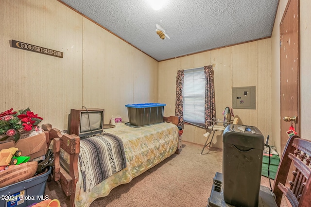 carpeted bedroom with electric panel, a textured ceiling, and ornamental molding