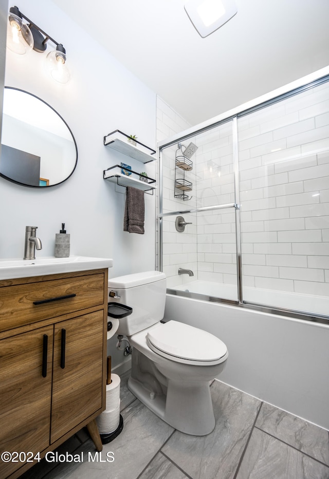 full bathroom with vanity, toilet, and shower / bath combination with glass door