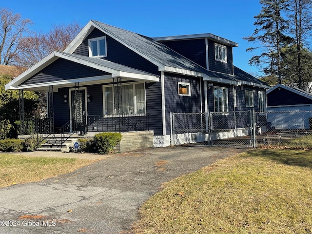 view of front facade with a front yard and a porch