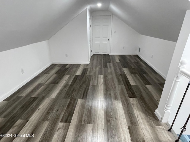 additional living space with dark hardwood / wood-style floors and vaulted ceiling