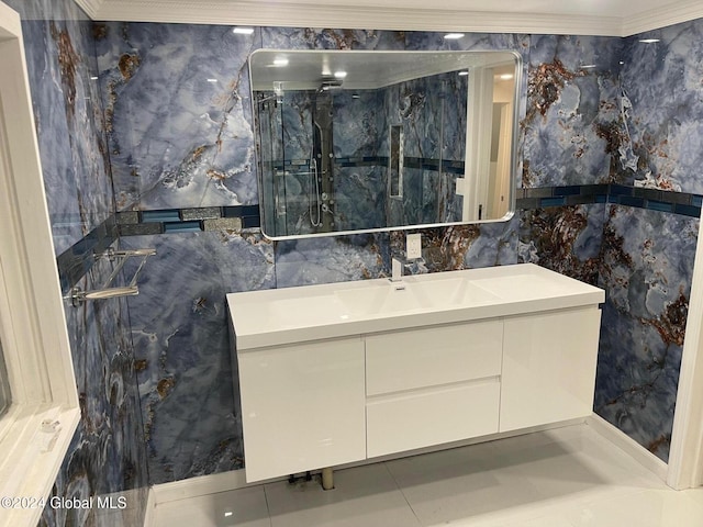 bathroom featuring tile patterned flooring, a shower with door, tile walls, and crown molding