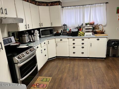 kitchen featuring white cabinets, stainless steel appliances, dark wood-type flooring, and exhaust hood