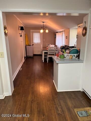 kitchen featuring vaulted ceiling, radiator heating unit, a chandelier, and dark hardwood / wood-style floors