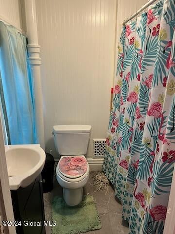 bathroom featuring tile patterned floors, curtained shower, vanity, and toilet