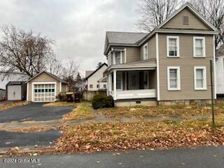 view of home's exterior featuring a garage and an outdoor structure