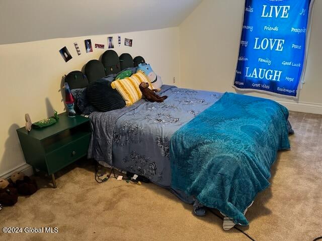 bedroom with carpet and lofted ceiling