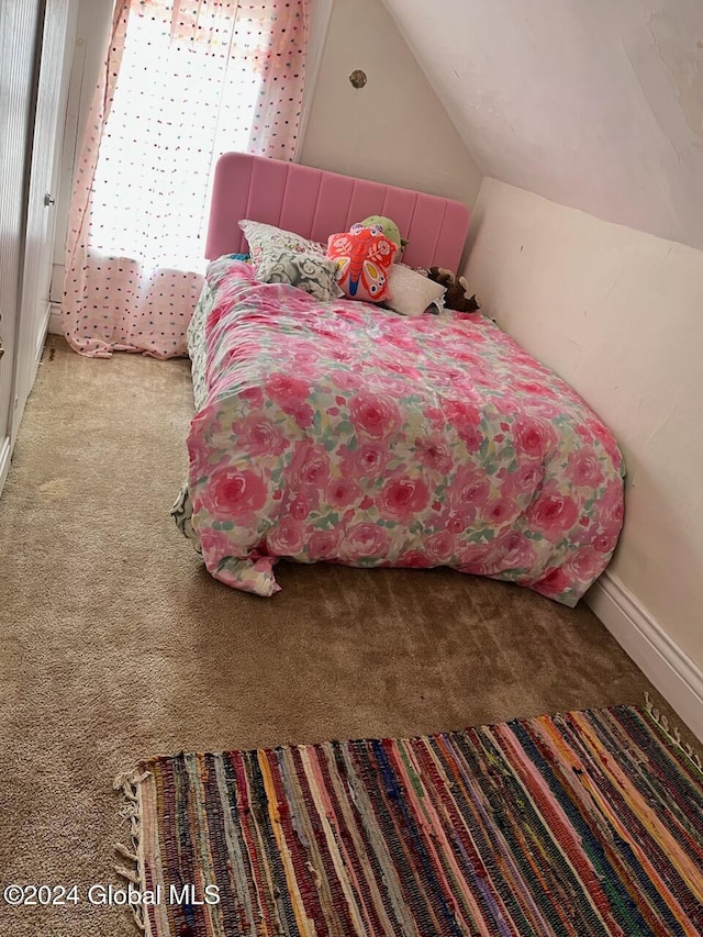 carpeted bedroom with vaulted ceiling