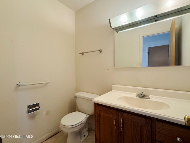 bathroom featuring tile patterned floors, vanity, and toilet