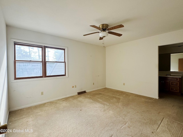 unfurnished room with ceiling fan and light colored carpet