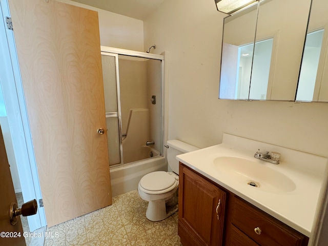 full bathroom featuring vanity, toilet, and enclosed tub / shower combo