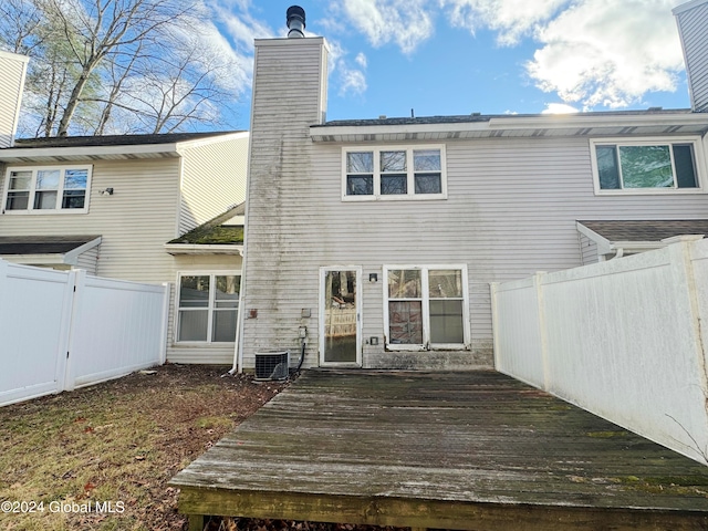 rear view of property with a deck and central air condition unit