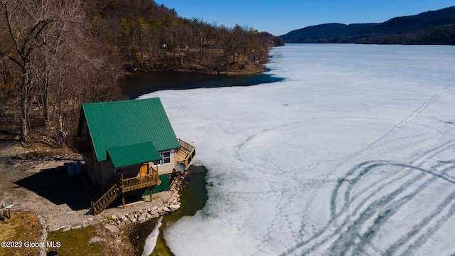 birds eye view of property with a water and mountain view