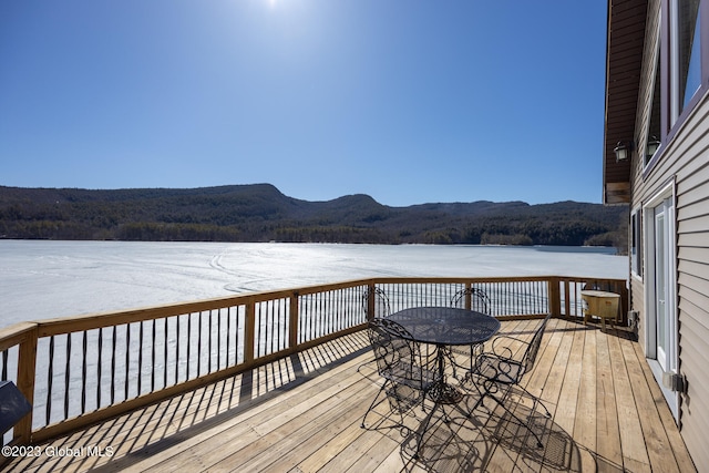 wooden deck featuring a water and mountain view