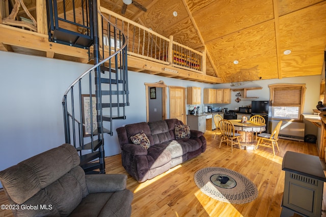 living room with high vaulted ceiling and light hardwood / wood-style floors