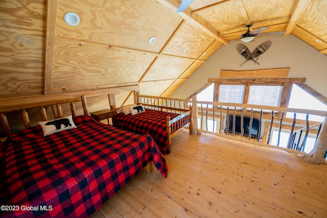 bedroom featuring lofted ceiling with beams and hardwood / wood-style flooring