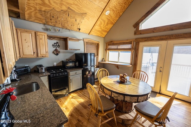 dining room featuring sink, high vaulted ceiling, light hardwood / wood-style floors, and french doors