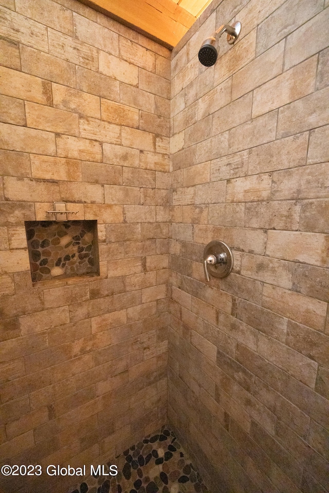 bathroom with a tile shower