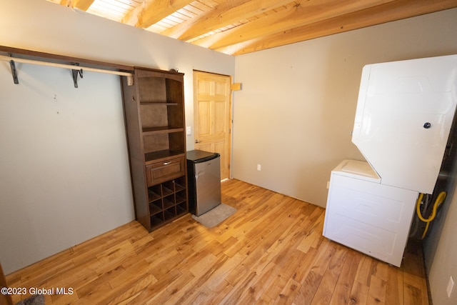 interior space featuring stainless steel fridge, light wood-type flooring, and wood ceiling