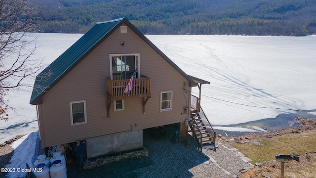 view of snowy exterior featuring a balcony