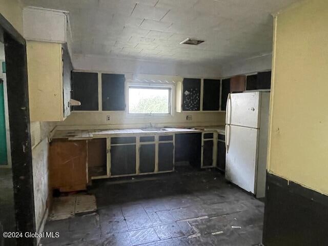 kitchen featuring sink and white refrigerator