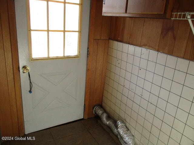 doorway with dark tile patterned flooring