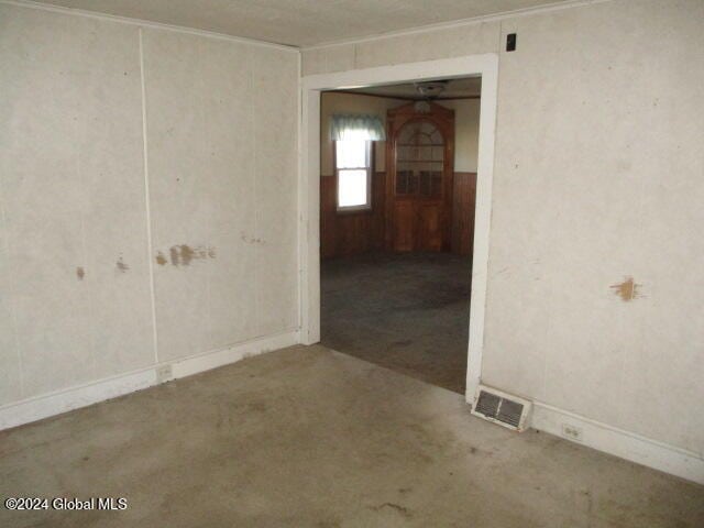 unfurnished room featuring crown molding