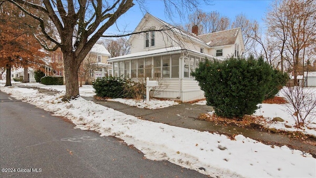 view of front of property featuring a sunroom