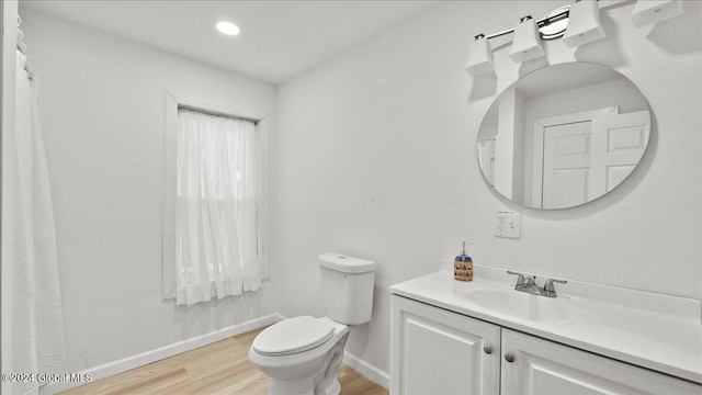 bathroom with vanity, hardwood / wood-style flooring, and toilet