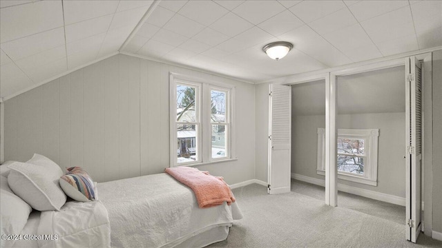 bedroom featuring light carpet and lofted ceiling