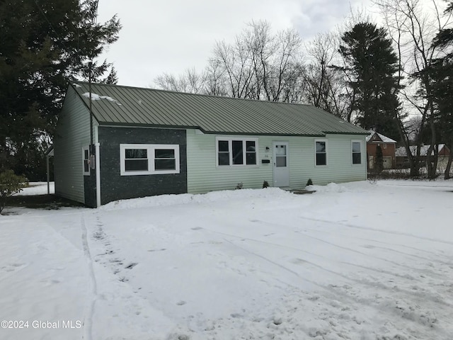 view of snow covered rear of property