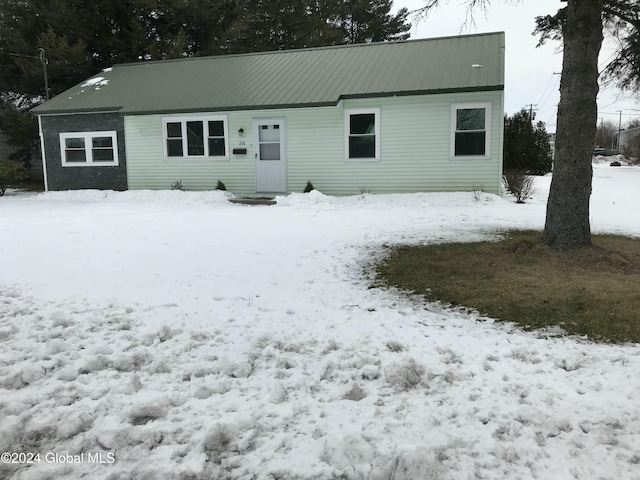 view of snow covered rear of property