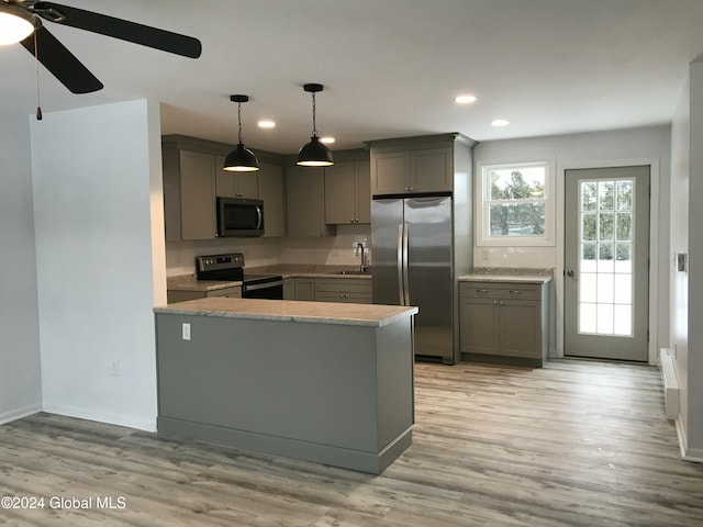 kitchen featuring gray cabinetry, light hardwood / wood-style floors, and appliances with stainless steel finishes