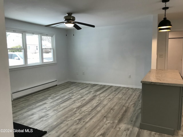 unfurnished living room with hardwood / wood-style floors, ceiling fan, and a baseboard radiator