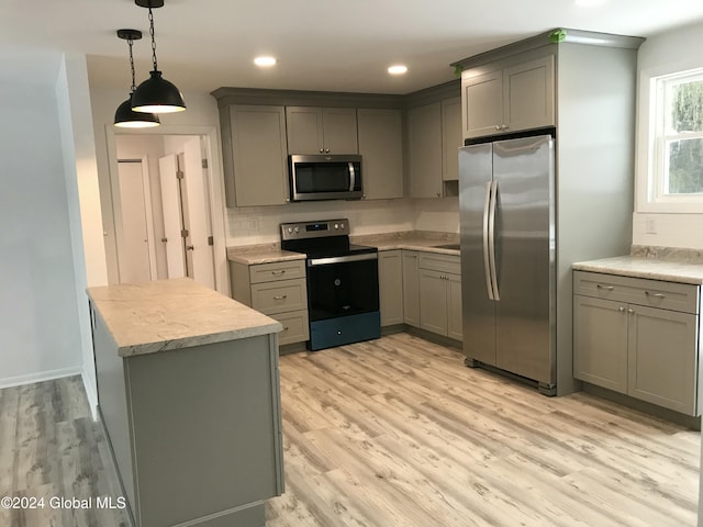 kitchen featuring gray cabinetry, stainless steel appliances, and light hardwood / wood-style flooring