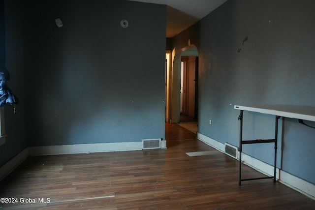 unfurnished room featuring dark wood-type flooring