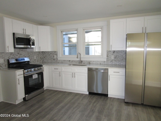 kitchen featuring dark hardwood / wood-style floors, white cabinetry, sink, and appliances with stainless steel finishes