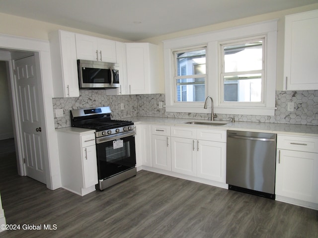 kitchen featuring dark wood-type flooring, sink, white cabinets, and stainless steel appliances