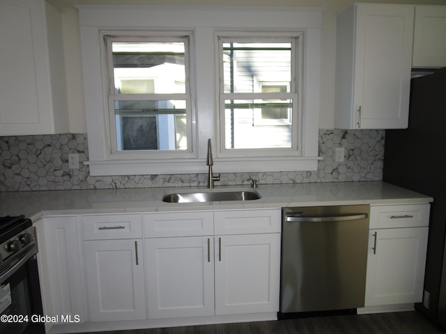 kitchen featuring white cabinets, tasteful backsplash, sink, dishwasher, and dark hardwood / wood-style floors