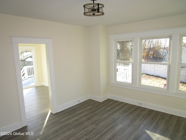 unfurnished dining area featuring dark hardwood / wood-style floors and a chandelier