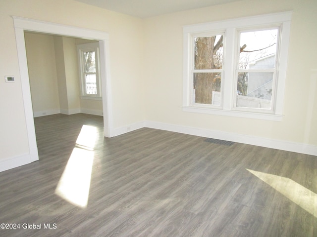 unfurnished room with dark hardwood / wood-style flooring