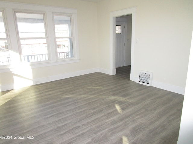 empty room with dark wood-type flooring