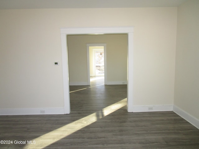 spare room with dark hardwood / wood-style floors